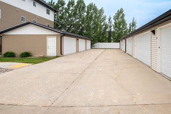 A driveway with a row of garages on either side